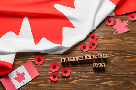 Poppy flowers with flags of Canada on wooden background. Remembrance Dayの写真素材