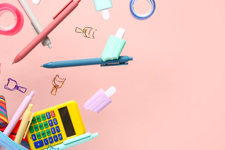 Flying stationery on pink backgroundの写真素材