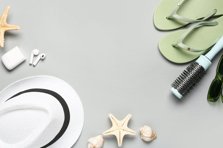 Composition with beach accessories, hair brush and earphones on gray backgroundの写真素材