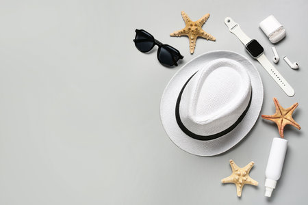 Composition with beach accessories, modern gadgets and starfishes on gray backgroundの写真素材