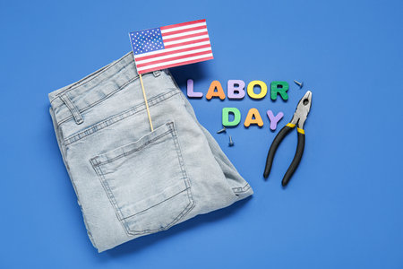 USA flag, jeans, pliers and text LABOR DAY on blue backgroundの写真素材