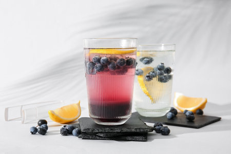 Glasses of fresh blueberry lemonade on white backgroundの写真素材