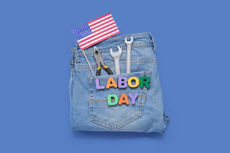 Jeans with different tools, USA flag and text LABOR DAY on blue backgroundの写真素材