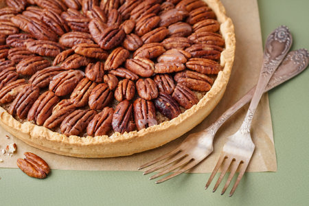 Tasty pecan pie on green backgroundの写真素材