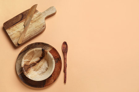 Different wooden tableware on beige backgroundの写真素材