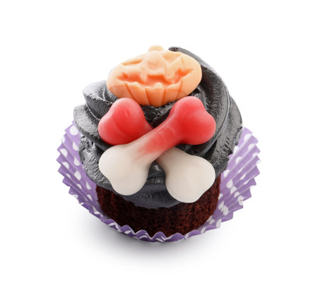 Delicious Halloween cupcake with candies on white backgroundの写真素材