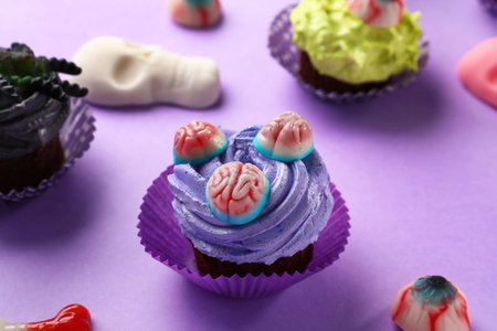 Delicious Halloween cupcake and candies on purple background, closeupの写真素材