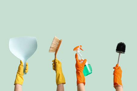 Women with cleaning supplies on green backgroundの写真素材
