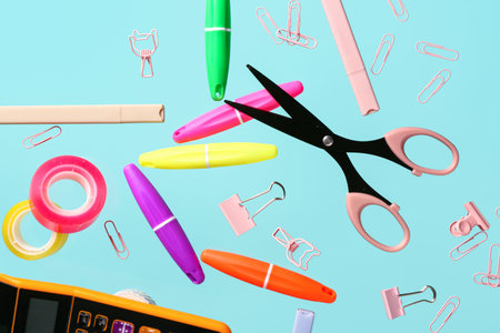 Bright stationery flying on color background