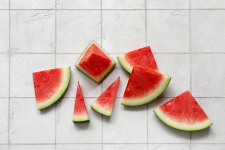Pieces of fresh watermelon on white tile backgroundの写真素材