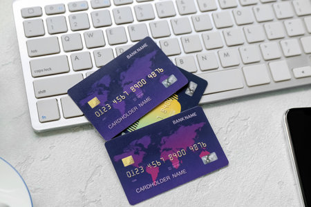 Keyboard with credit cards on color backgroundの写真素材