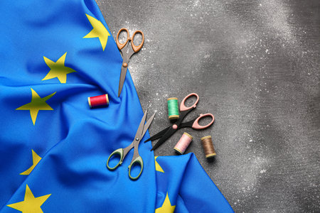 Flag of European Union with scissors  on gray grunge backgroundの写真素材