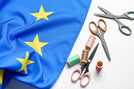 Scissors, threads and flag of European Union on white backgroundの写真素材