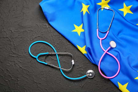 Flag of European Union and stethoscopes on black backgroundの写真素材