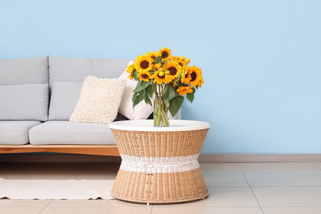 Vase with beautiful sunflowers on coffee table in living roomの写真素材