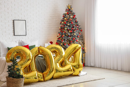 Balloons in shape of figure 2024 in festive bedroom with Christmas decorの写真素材