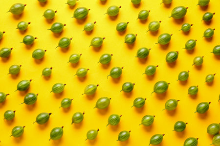 Many fresh gooseberries on yellow backgroundの写真素材