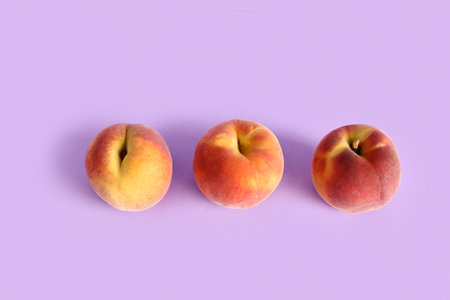Sweet peaches on lilac backgroundの写真素材