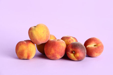Many sweet peaches on lilac backgroundの写真素材