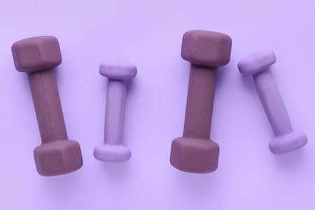 Set of dumbbells on lilac backgroundの写真素材
