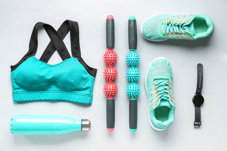 Composition with sportswear, shoes, equipment and smartwatch on light backgroundの写真素材