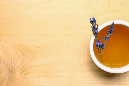 Bowl of sweet lavender honey on wooden backgroundの写真素材