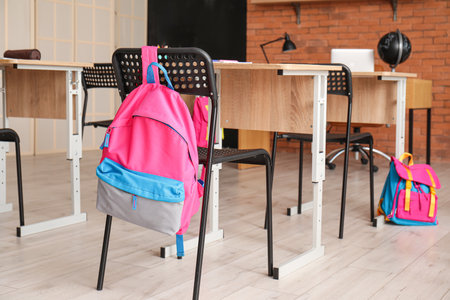 Interior of stylish empty classroom with backpacks and stationeryの写真素材
