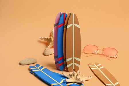 Different mini surfboards, sunglasses and starfishes on yellow backgroundの写真素材