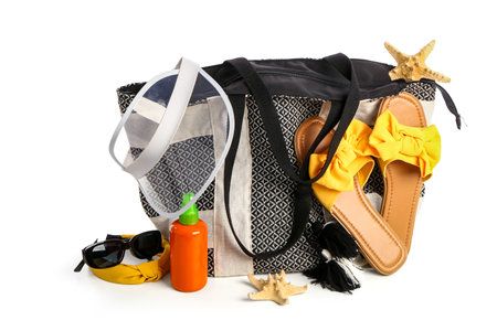 Bottle of sunscreen cream with beach accessories isolated on white backgroundの写真素材