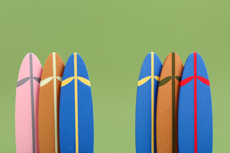 Different mini surfboards on green backgroundの写真素材