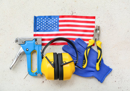 Earmuffs, tools, gloves and USA flag on white background. labor day celebrationの写真素材