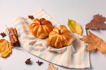 Tasty pumpkin shaped buns on gray backgroundの写真素材
