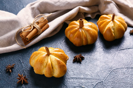 Tasty pumpkin shaped buns on black backgroundの写真素材