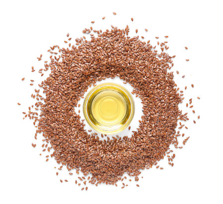 Glass bowl of flax oil and seeds on white backgroundの写真素材