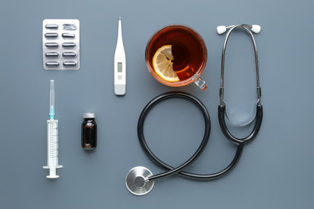 Stethoscope, cup of tea and pills on gray backgroundの素材 [FY310210710805]