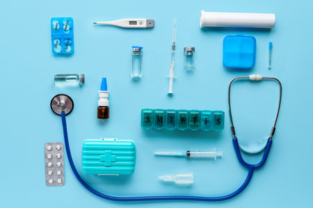 Composition with stethoscope, syringes, pills and medicine on blue backgroundの写真素材