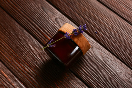 Jar of cosmetic product and lavender flower on dark wooden backgroundの写真素材