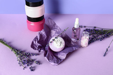 Composition with cosmetic products and aromatic lavender flowers on color backgroundの写真素材
