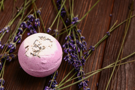 Composition with bath bomb and lavender flowers on dark wooden tableの写真素材