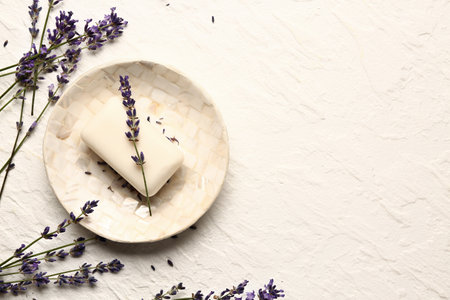 Dish with soap and and lavender flowers on light backgroundの写真素材