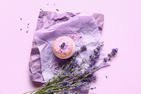 Bath bomb, sea salt and lavender flowers on color backgroundの写真素材