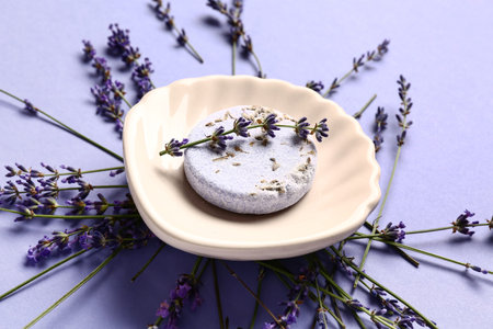 Composition with soap bar and aromatic lavender flowers on color backgroundの写真素材