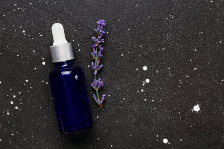 Bottle of lavender essential oil on dark backgroundの写真素材