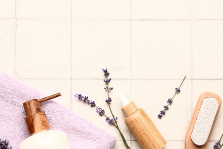 Composition with cosmetic products, bath supplies and lavender flowers on light tile backgroundの写真素材