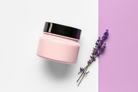 Jar of cosmetic product and lavender flowers on color backgroundの写真素材