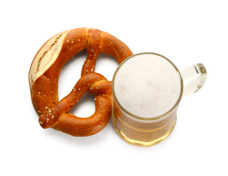 Mug of cold beer and pretzel on white backgroundの写真素材
