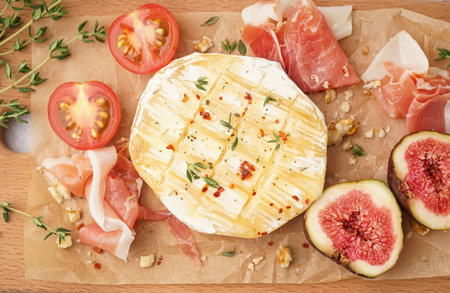 Tasty baked camembert cheese on tableの写真素材