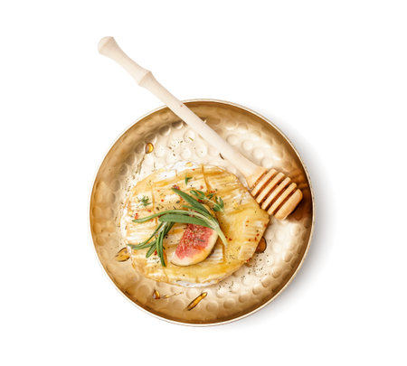 Plate with tasty baked Camembert cheese on white backgroundの写真素材
