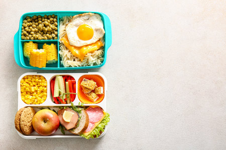 Lunchboxes with different delicious food on light backgroundの写真素材
