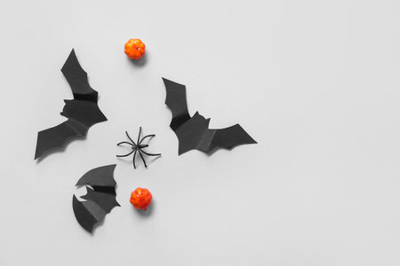 Composition with pumpkins, paper bats and spider on white background. halloween celebration conceptの写真素材